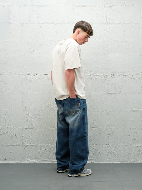 Denim Pant | Frost Rear on paired with cream t-shirt and solomons. 
