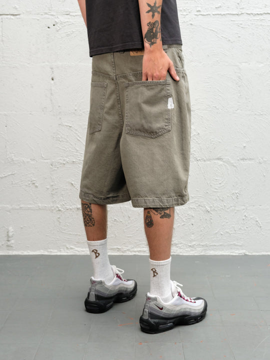 Model wearing Grab Tee faded black with Denim Short | Sage Baggys.uk close up of rear
