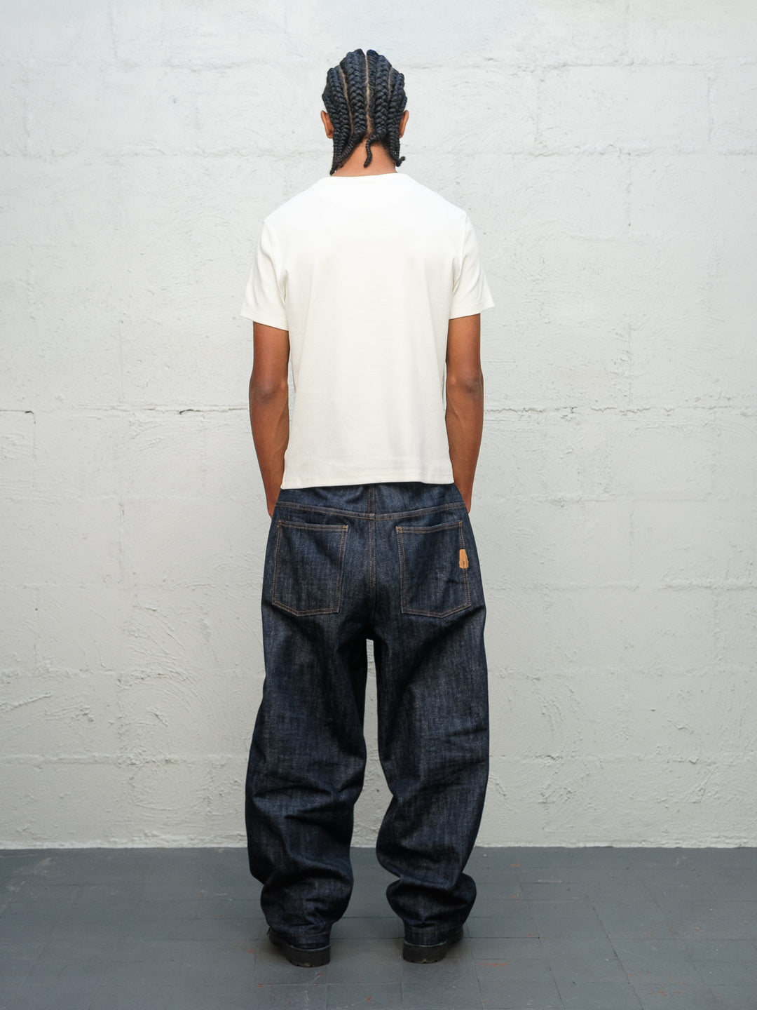 Model wearing white t-shirt and Denim Pant Indigo Selvedge Denim from rear