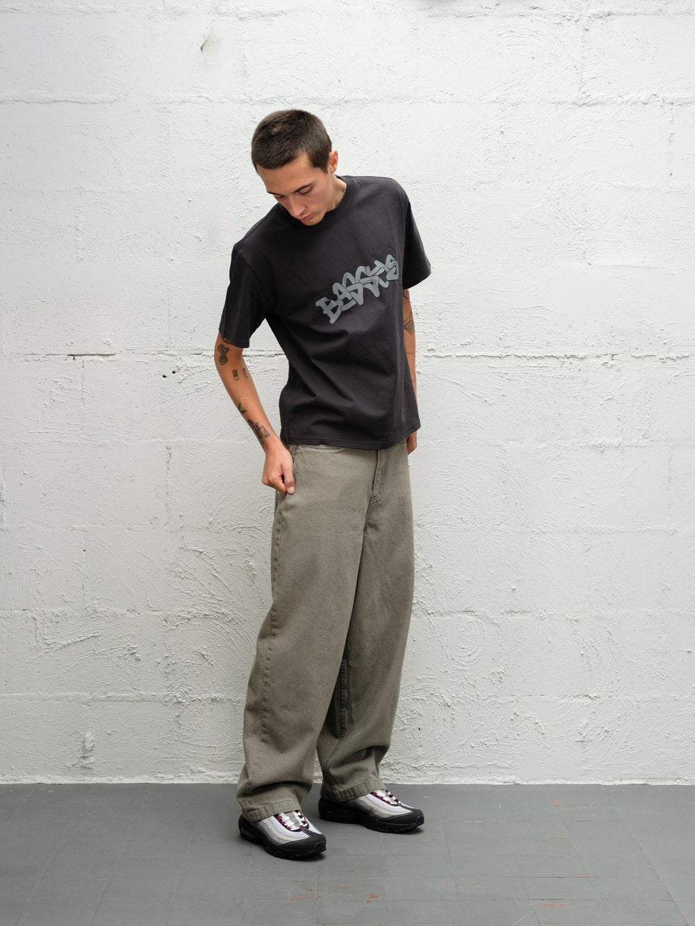 Model wearing Grab tee faded black with DENIM PANT | SAGE 