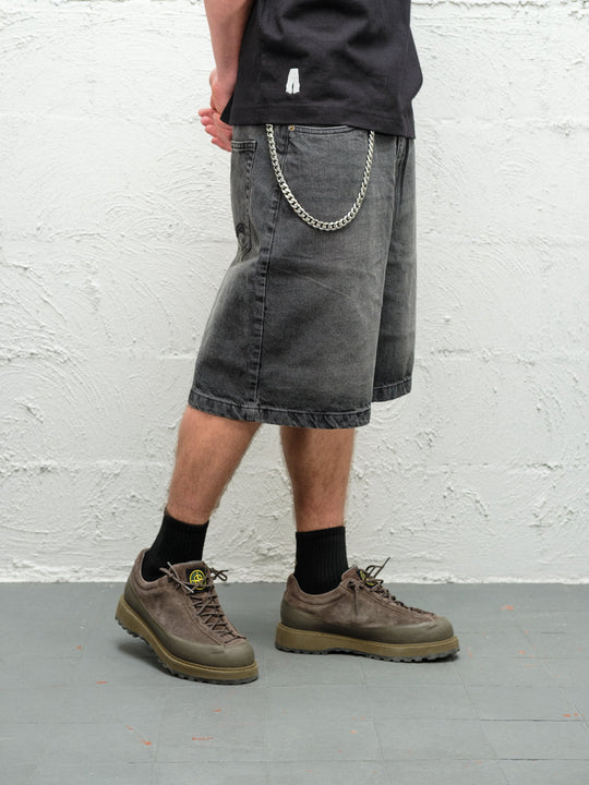 Person wearing black fade baggy denim shorts with the wallet chain