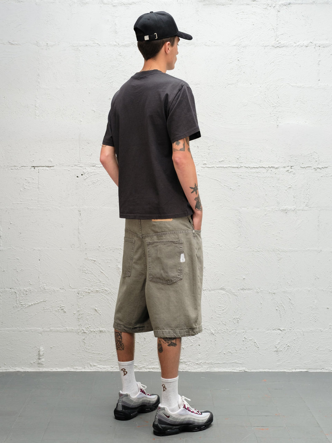 Model wearing Grab Tee faded black with Denim Short | Sage Baggys.uk rear