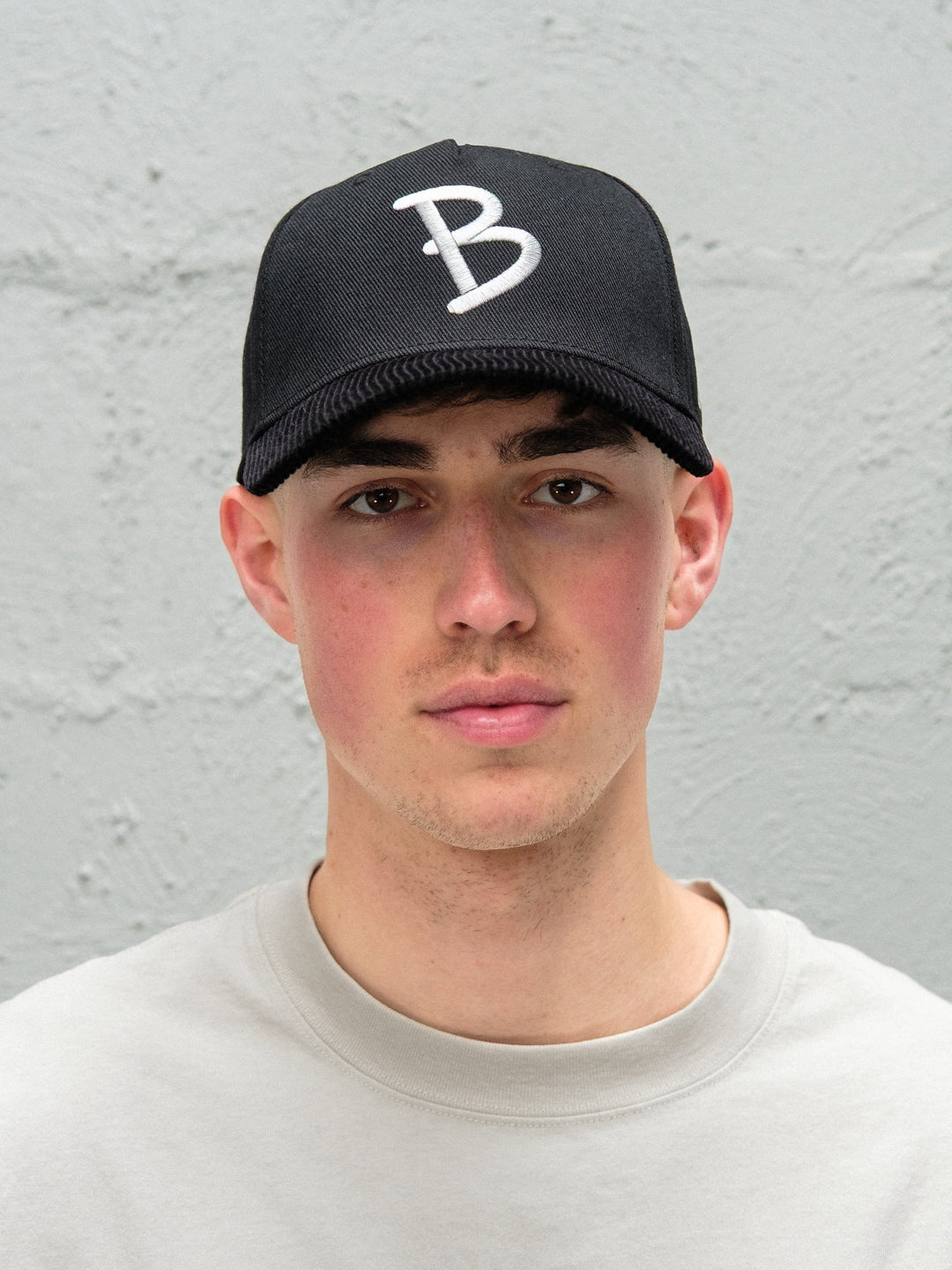 Person wearing Baggys 5-panel hat in black up close