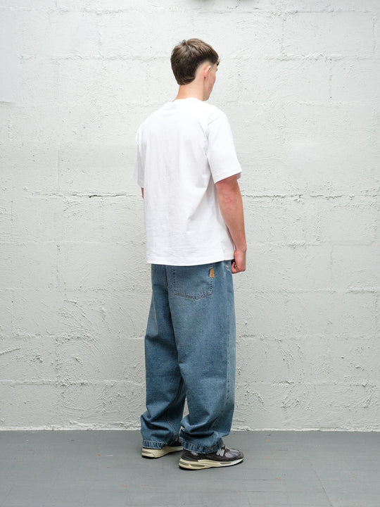 Model wearing Baggys Denim Pant Fray — light blue baggy jeans, rear view