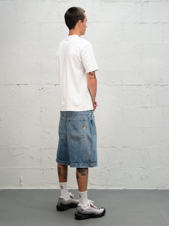 Model wearin Denim Short | Fray paired with 95's and a white t-shirt rear view