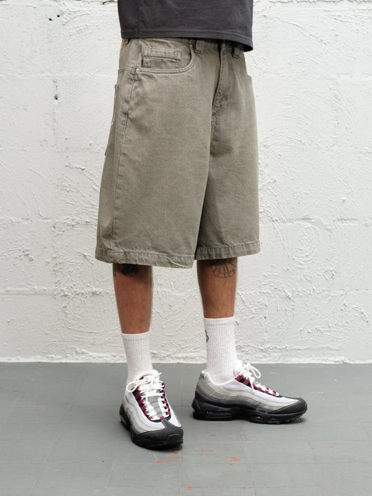 Model wearing Grab Tee faded black with Denim Short | Sage Baggys.uk close up of front