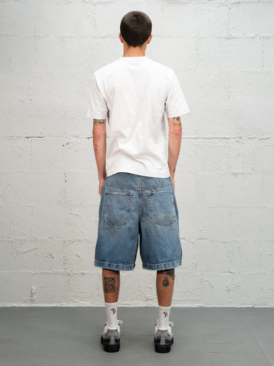 Model wearin Denim Short | Fray paired with 95's and a white t-shirt full rear view