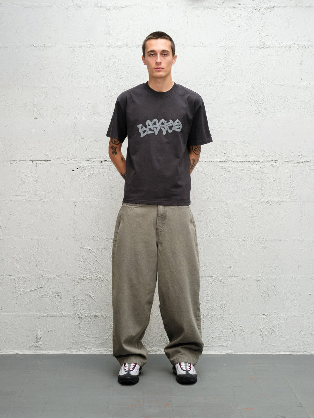 Model wearing Grab tee faded black with DENIM PANT | SAGE 