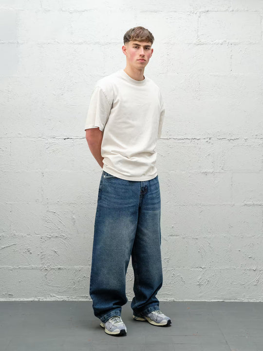 Person wearing black baggy denim frost jeans, made by Baggys.uk