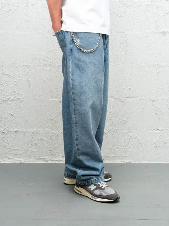 Person wearing Fray blue baggy denim pants with the wallet chain
