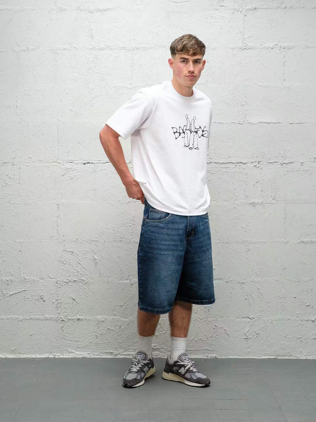 Person wearing blue baggy denim dove jean shorts, made by Baggys.uk