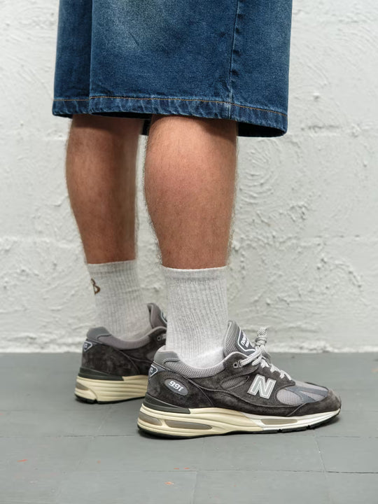 Person wearing Baggys sittin socks in marl grey