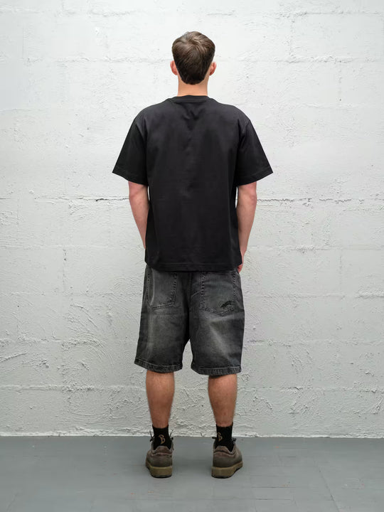 Person wearing black baggy denim fade jean shorts, made by Baggys.uk