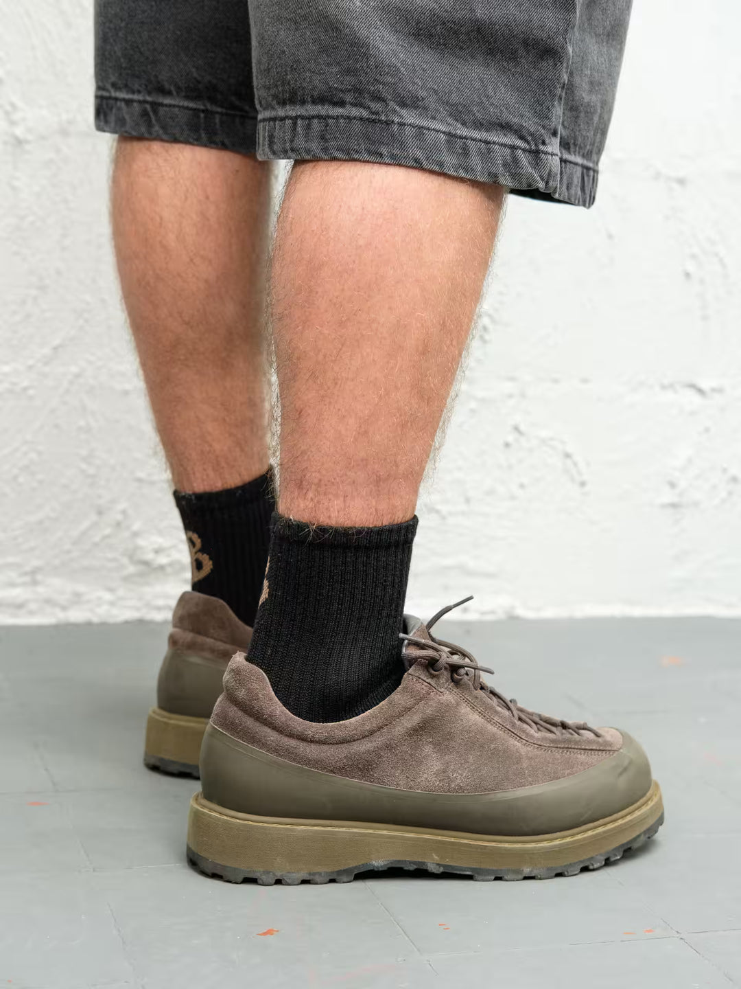 Person wearing Baggys sittin socks in black