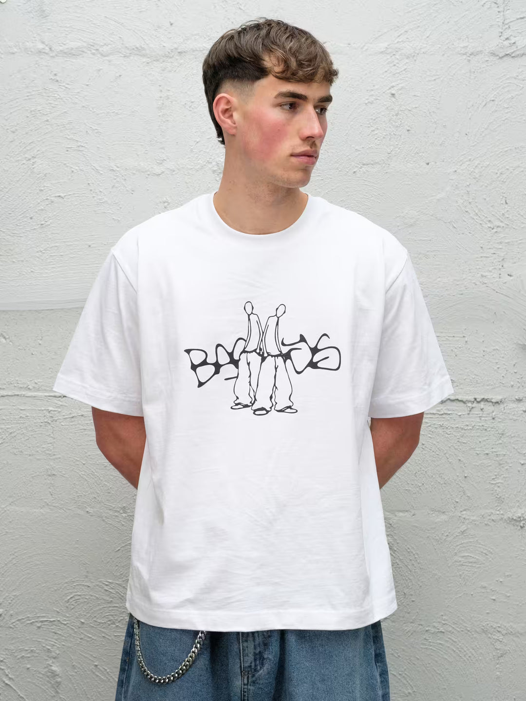 Person wearing white screen printed graphic t-shirt