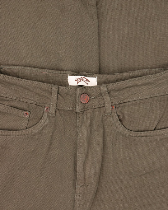 Close-up of brown pants with a brand label on the waistband.