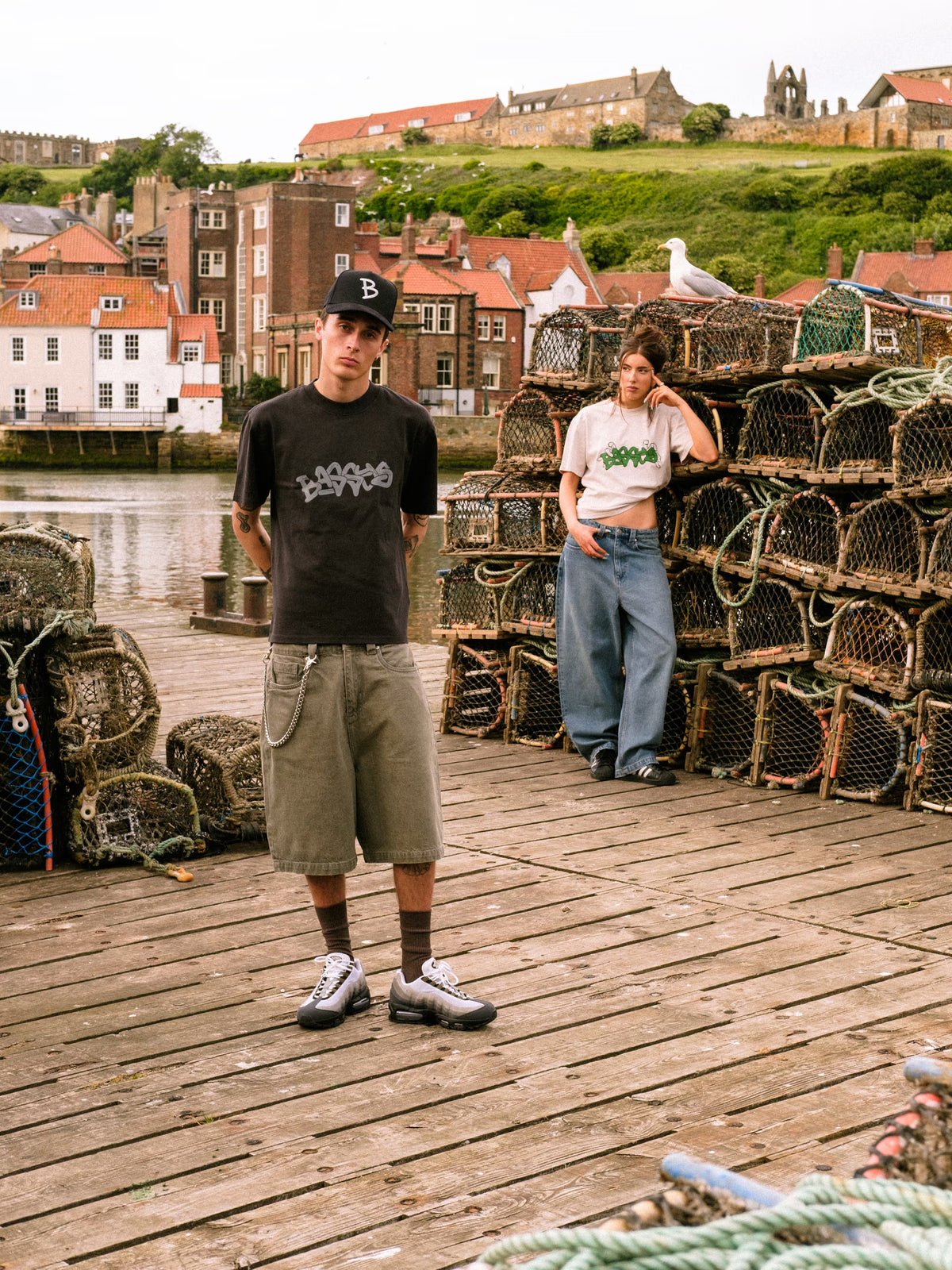 Models wearing Denim Short Sage and Denim Pant Fray, in the harbour with fish catching equipment