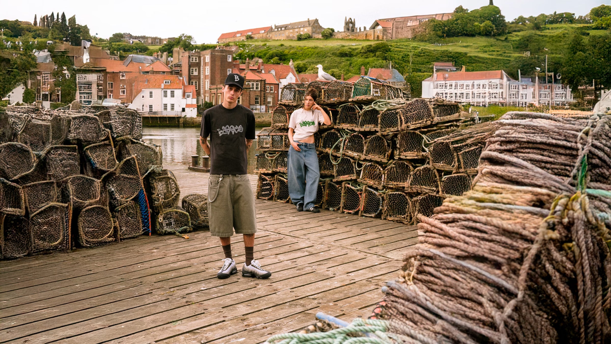 Models wearing Denim Short Sage and Denim Pant Fray, in the harbour with fish catching equipment