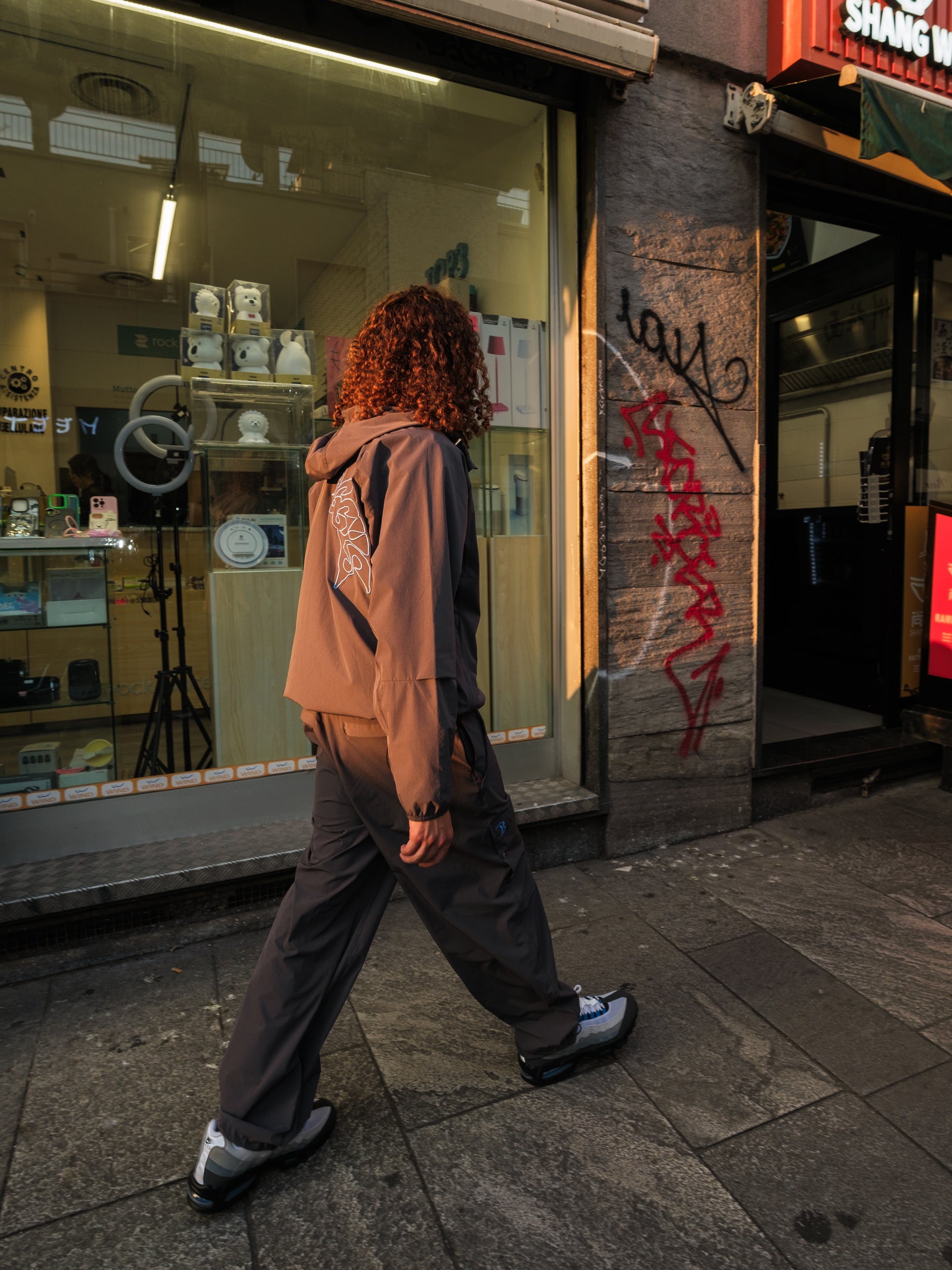 Young AB roaming the Milan streets in the full Baggys Oxide Tracksuit with Blue Spark Air Max 95s