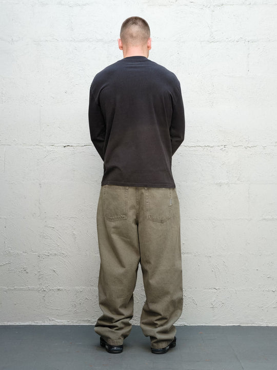 Model wearing Baggys Runnin' Man Tee in Faded Black, rear view