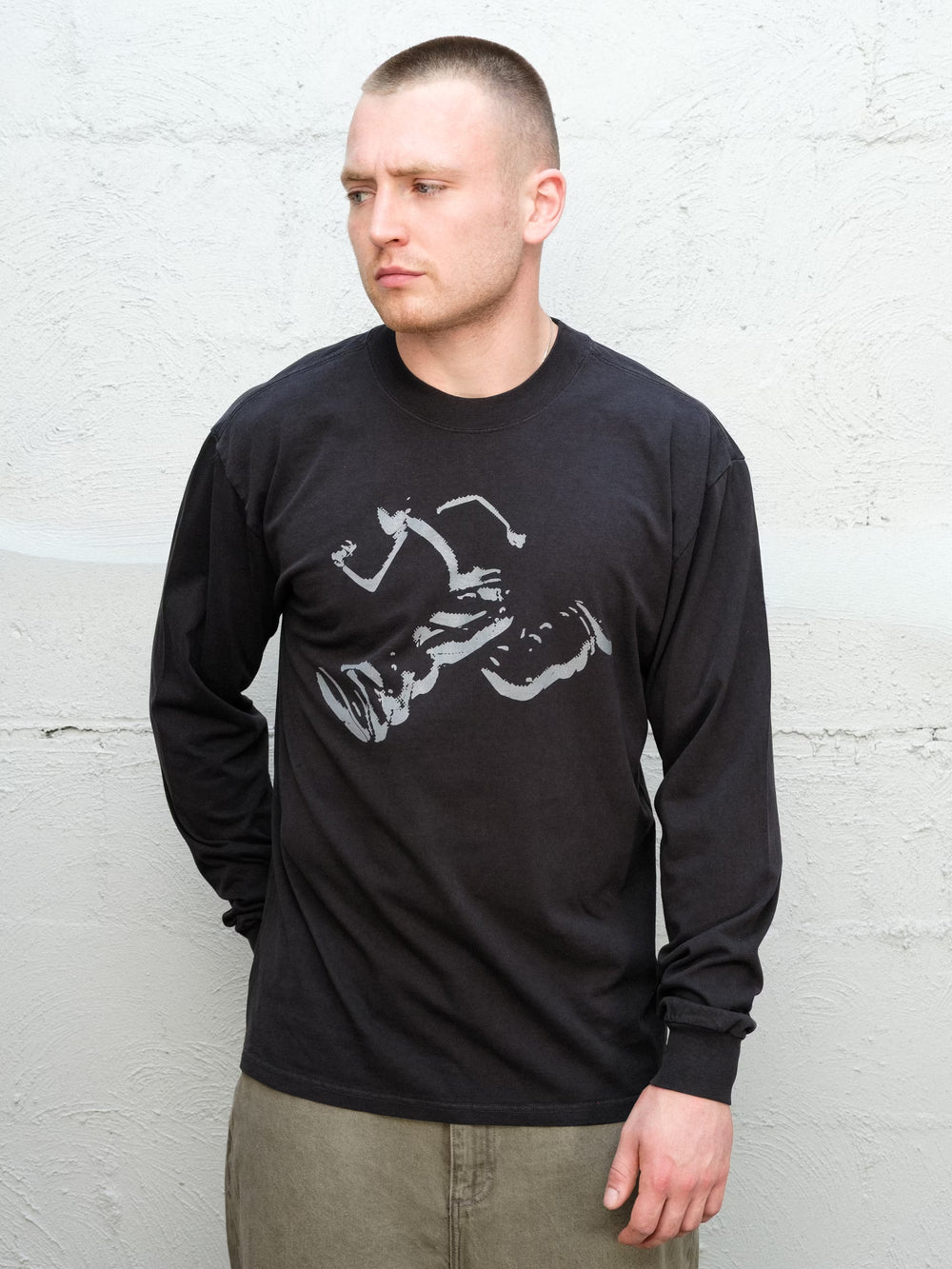 Model wearing Baggys Runnin' Man Tee in Faded Black, front view