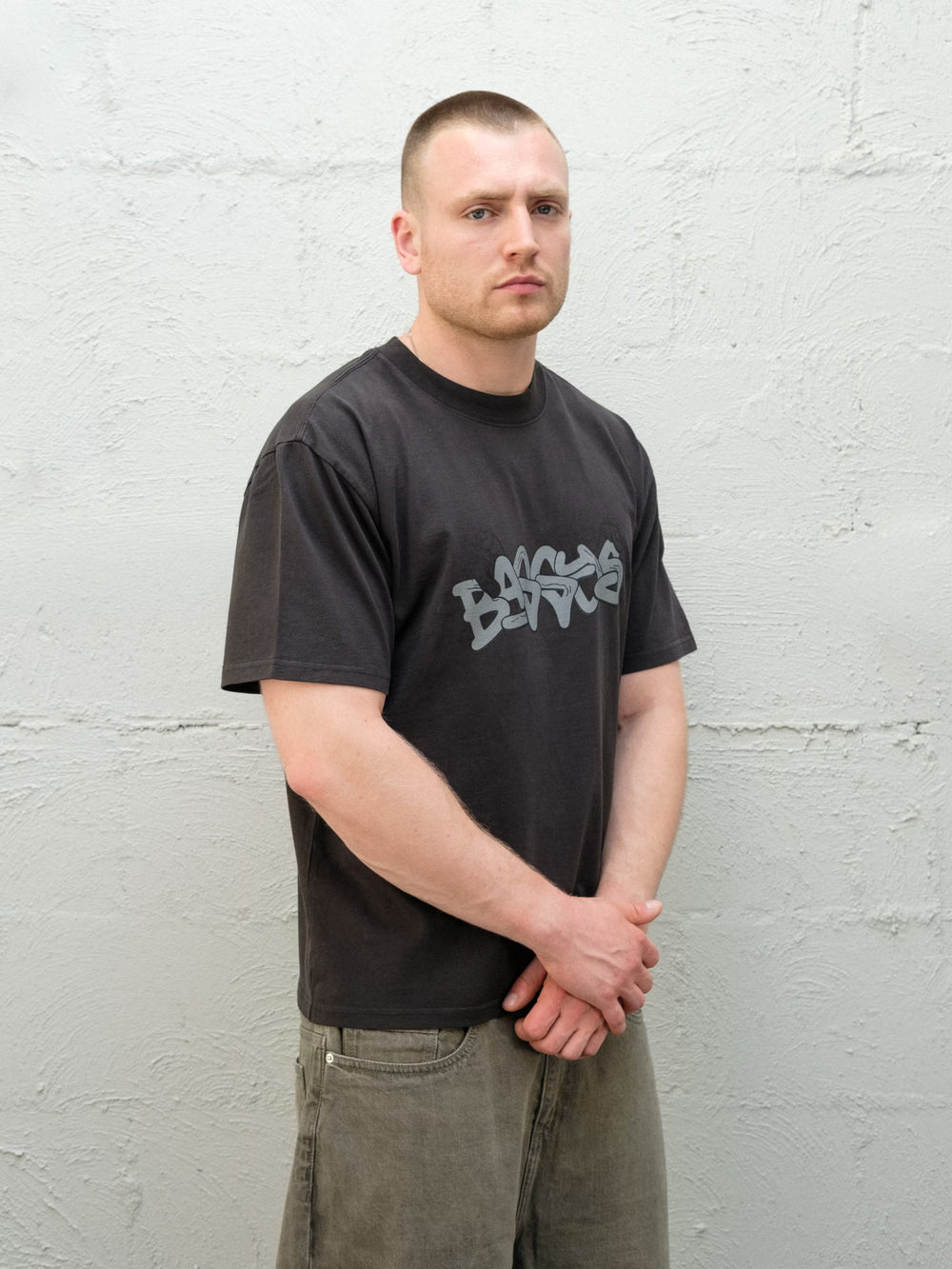 Model wearing Baggys Grab Tee in Faded Black, front view