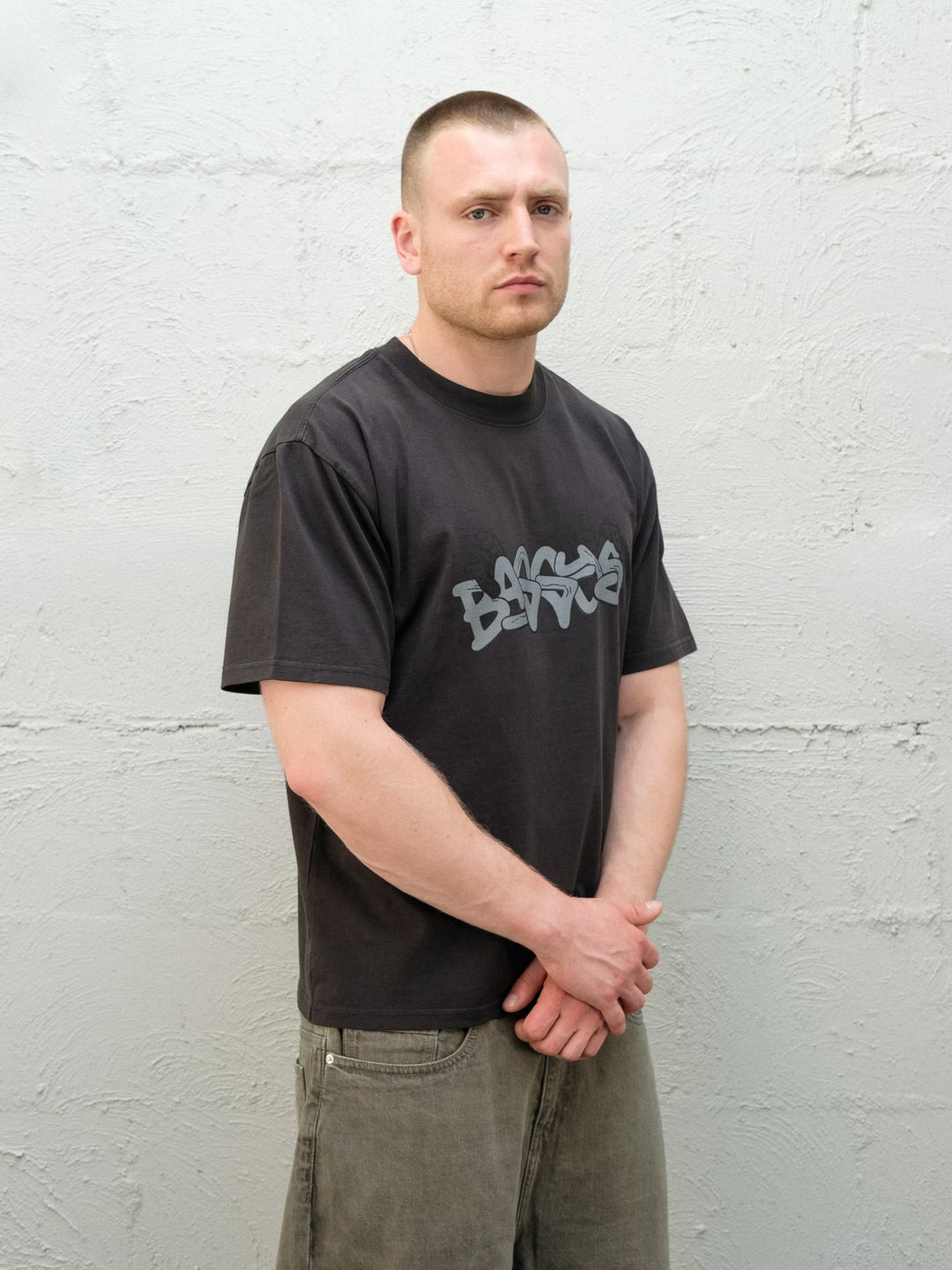 Model wearing Baggys Grab Tee in Faded Black, front view