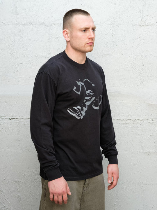 Model wearing Baggys Runnin' Man Tee in Faded Black, three-quarter view