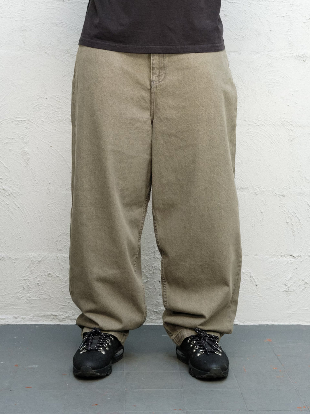 Model wearing Runnin man tee faded black with DENIM PANT | SAGE Baggys.uk