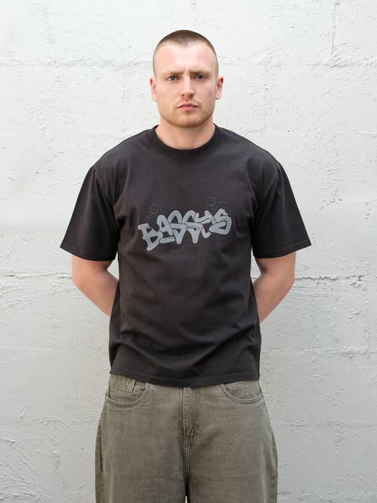 Model wearing Baggys Grab Tee in Faded Black, front view