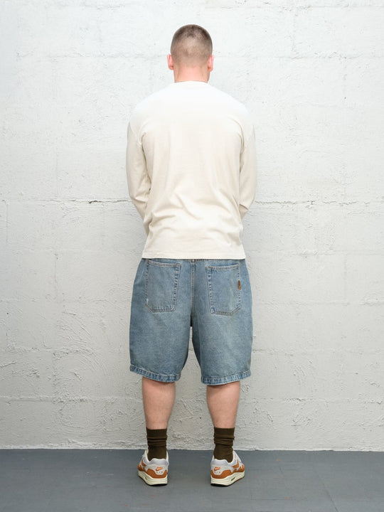 Model wearing Baggys Runnin' Man Tee in Faded Bone, rear view