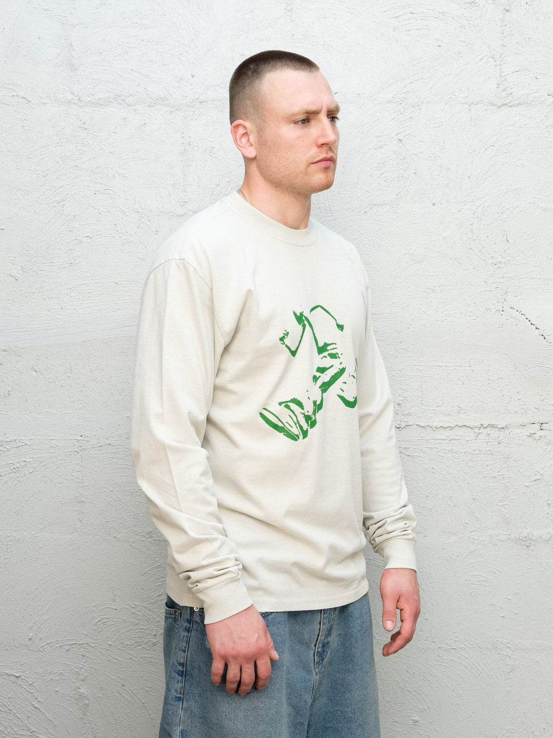 Model wearing Baggys Runnin' Man Tee in Faded Bone, three-quarter view