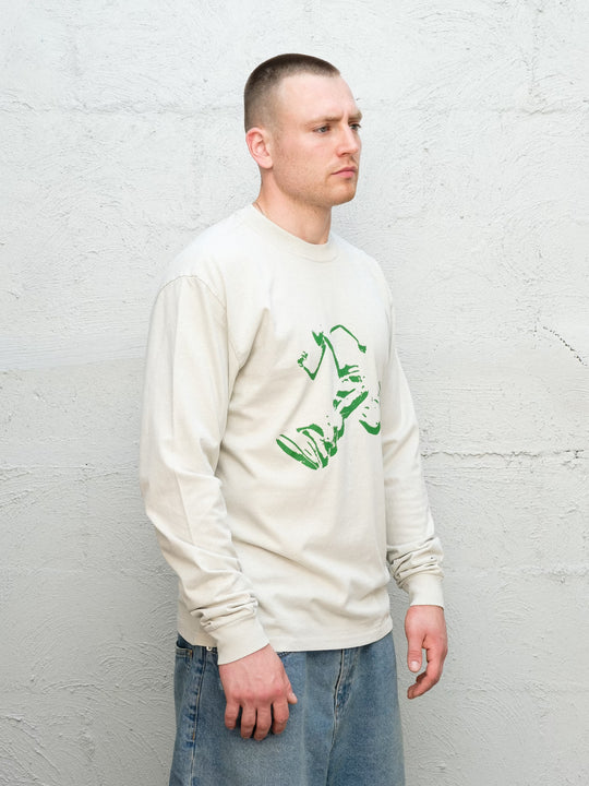 Model wearing Baggys Runnin' Man Tee in Faded Bone, three-quarter view