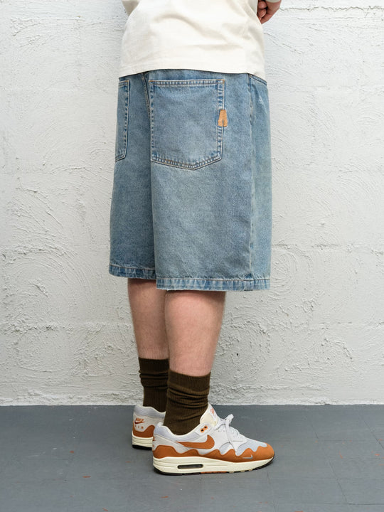 Model wearing Runnin' Man Tee in Bone and Denim Short | Fray 