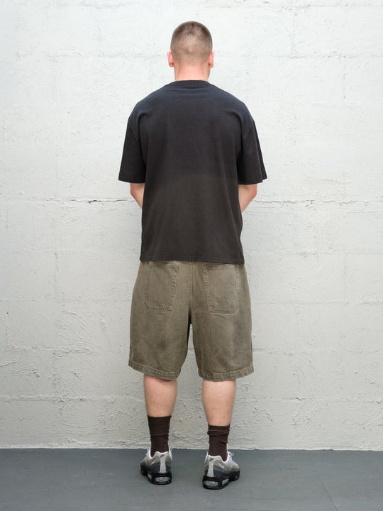 Model wearing Baggys Grab Tee in Faded Black, rear view