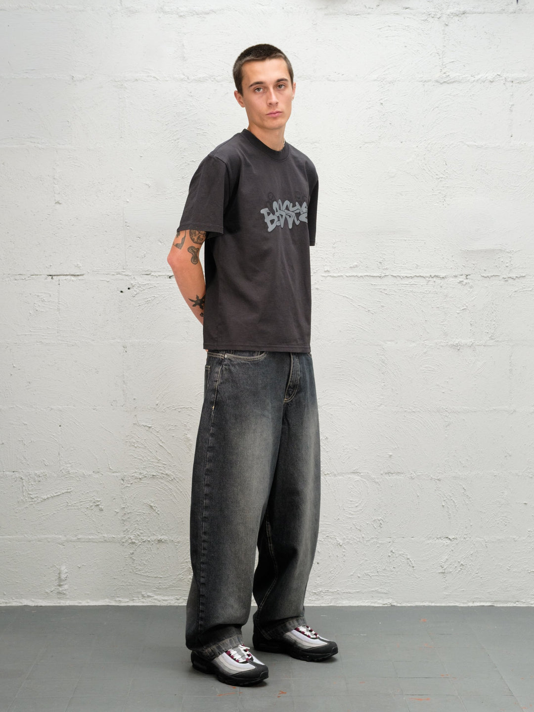 Model wearing grab tee with Denim Pant | Flint full side on virew