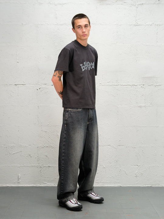 Model wearing grab tee with Denim Pant | Flint full side on virew