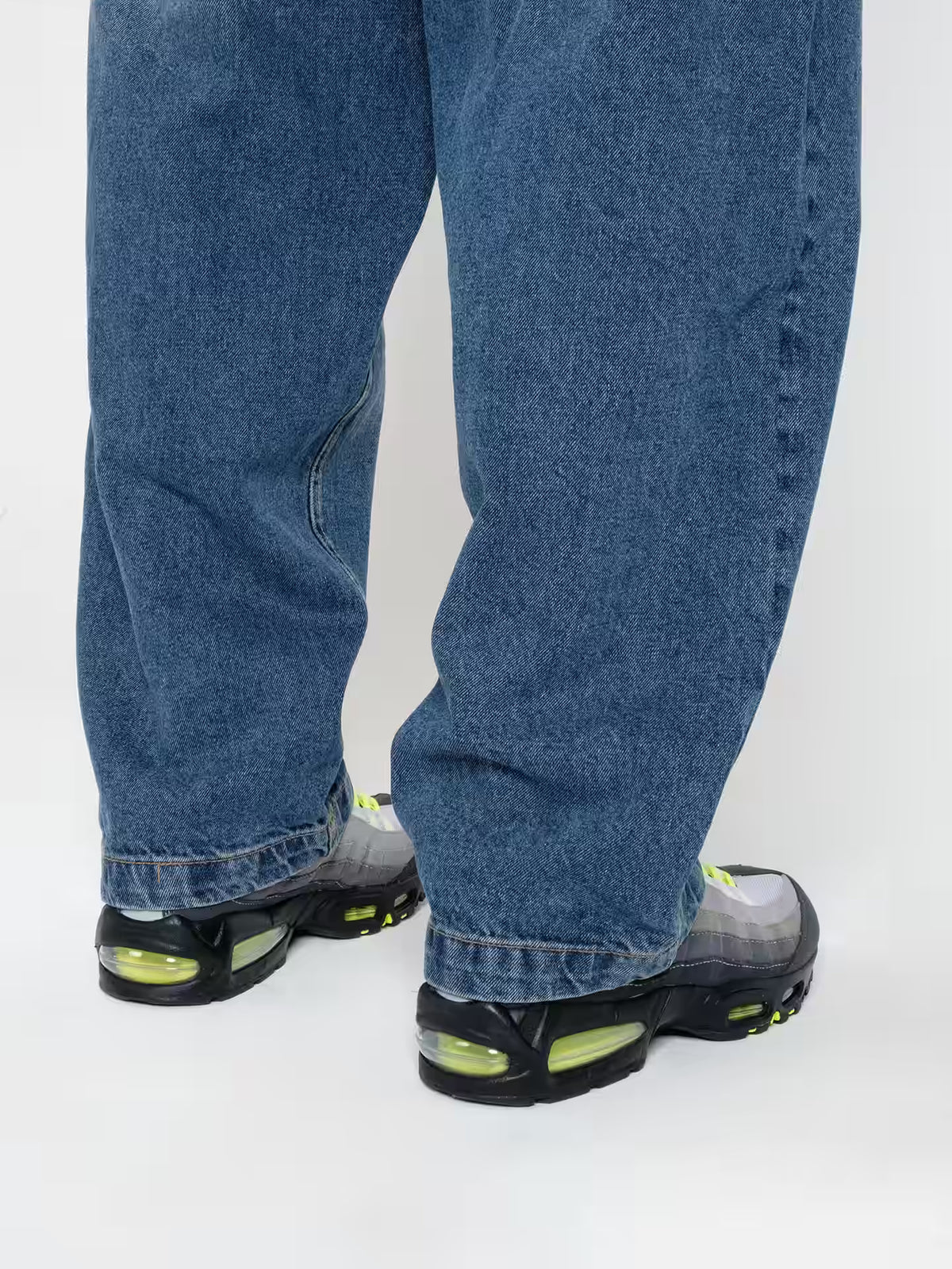 Person wearing Baggy Jeans Frost blue, showing the fit on the shoes