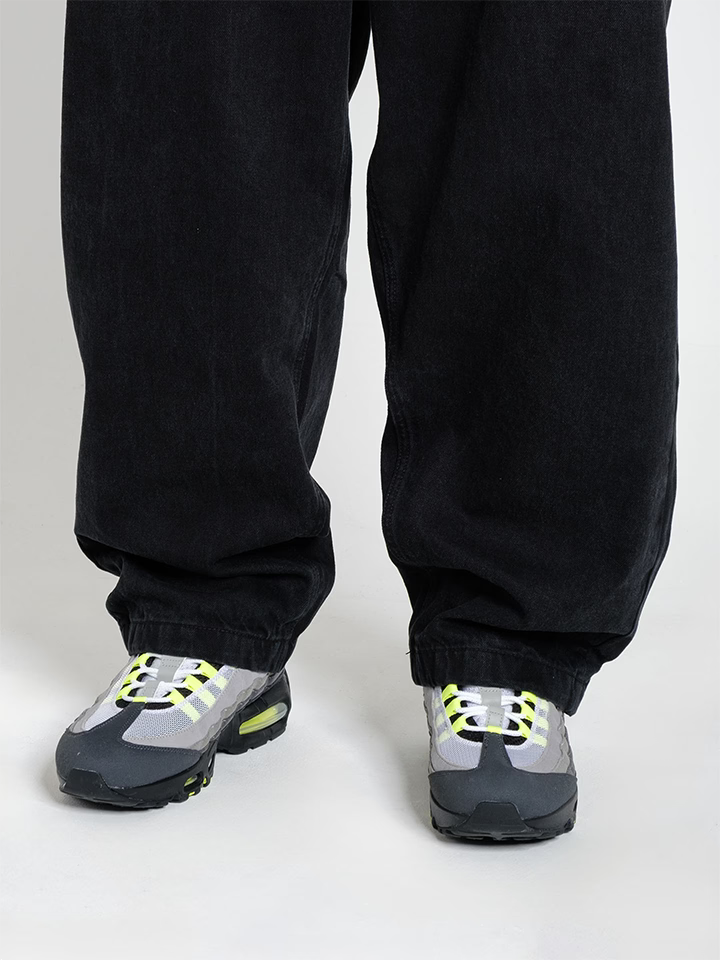 Person wearing Baggy Jeans Pitch denim, showing the fit on the shoes