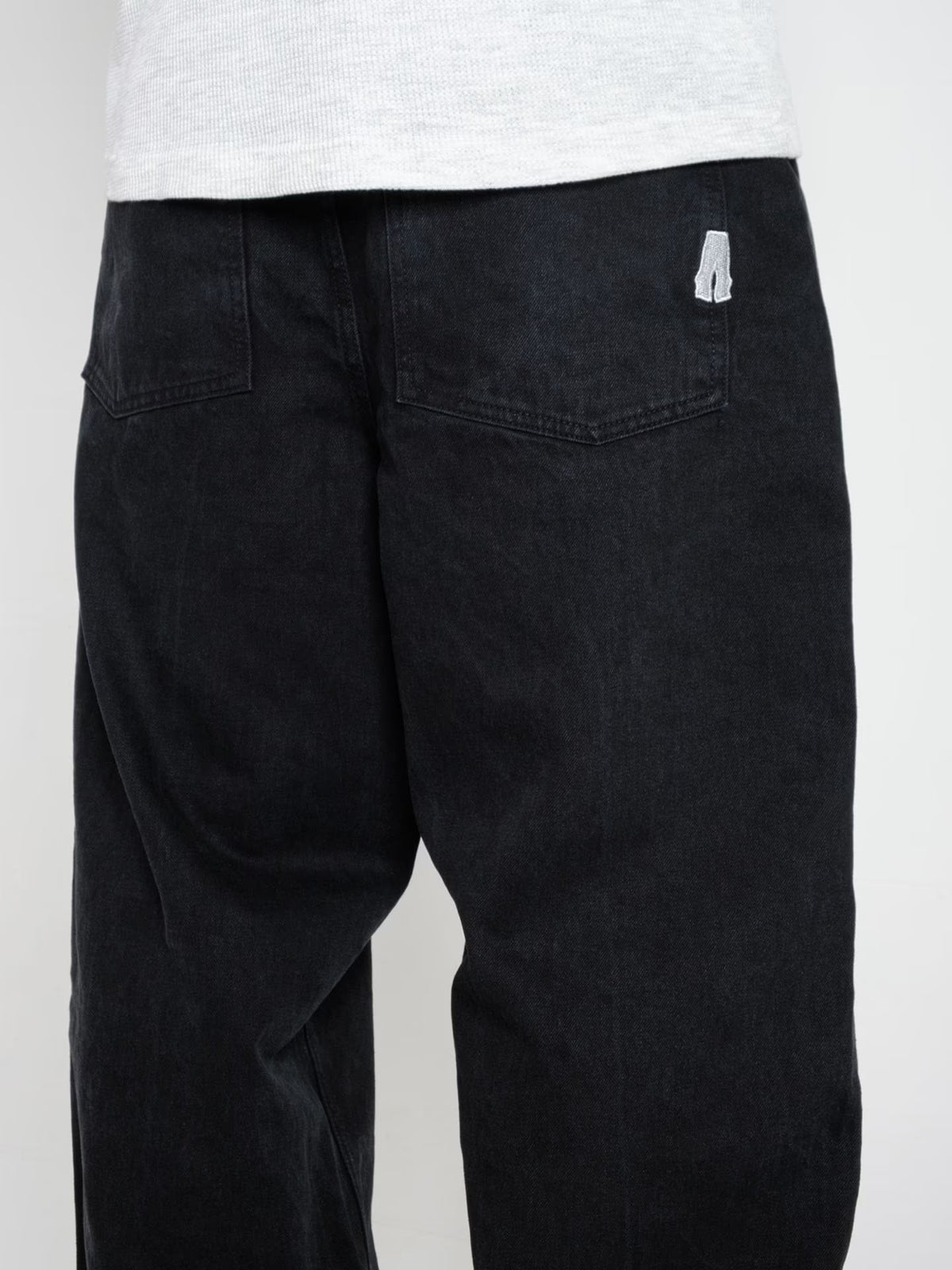 Person wearing Baggy Jeans Pitch denim, showing the rear