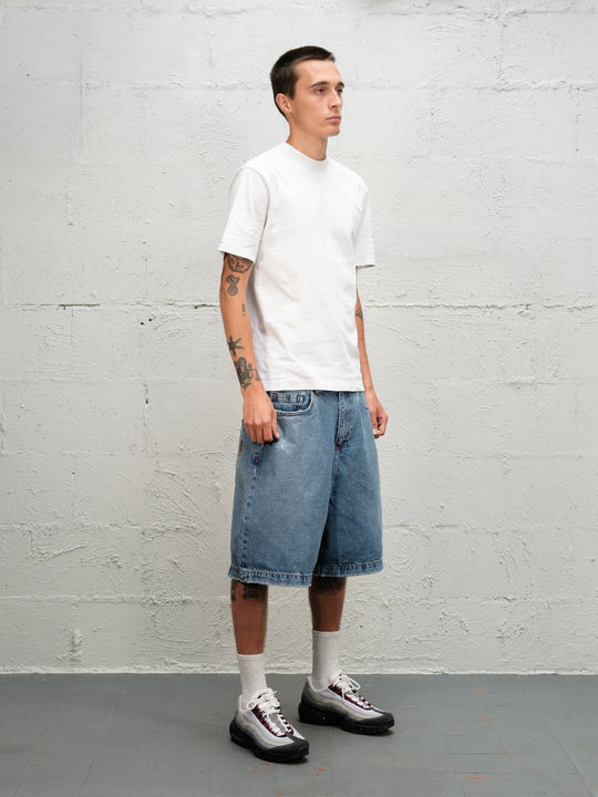 Model wearin Denim Short | Fray paired with 95's and a white t-shirt