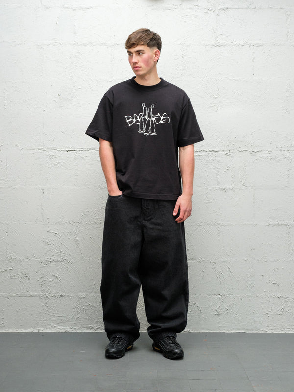 Person wearing black baggy denim pitch jeans, made by Baggys.uk