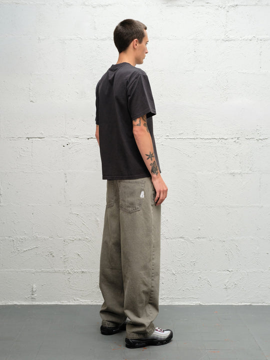 Model wearing Grab tee faded black with DENIM PANT | SAGE rear view