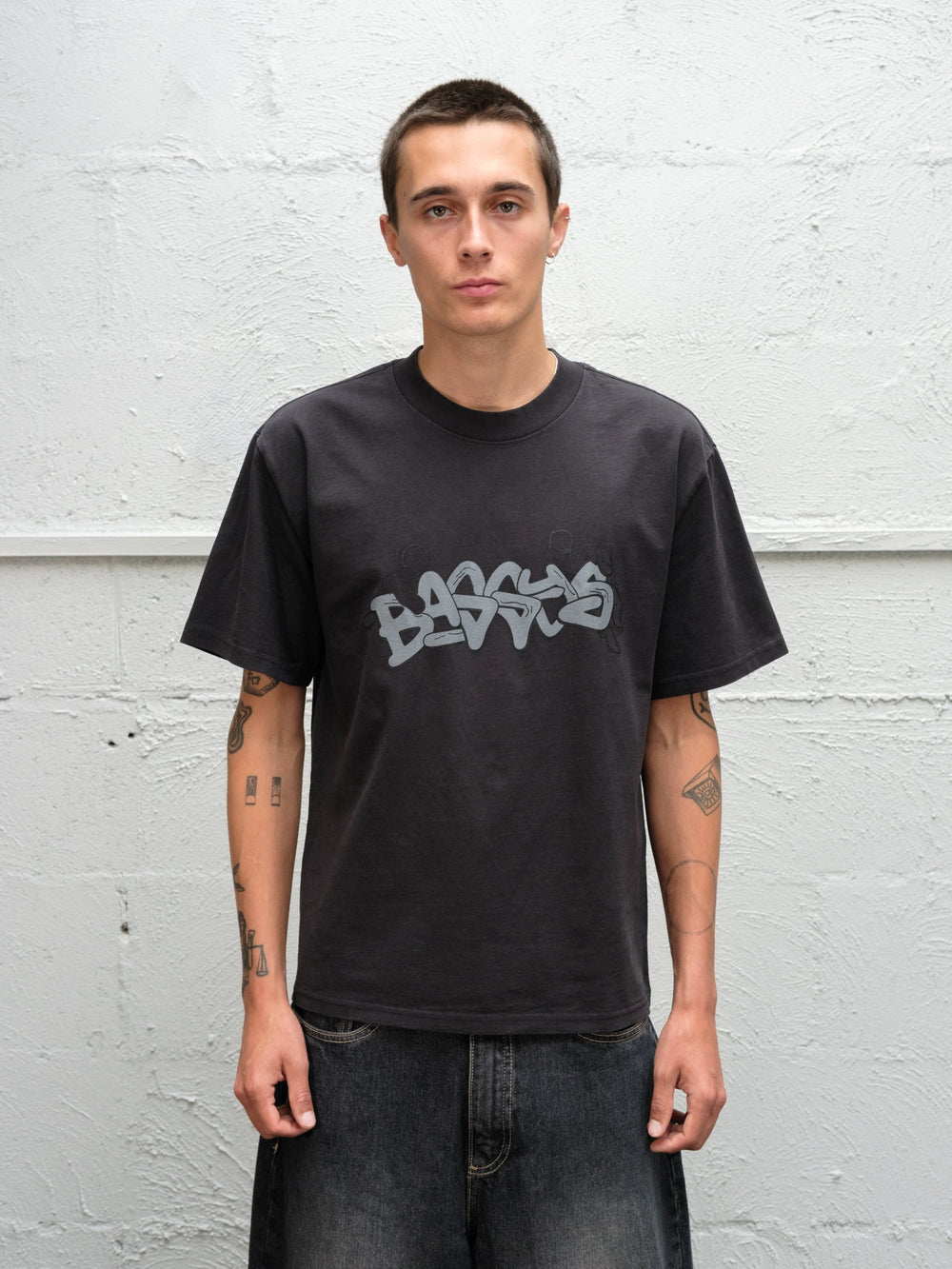 Model wearing Baggys Grab Tee in Faded Black, front view