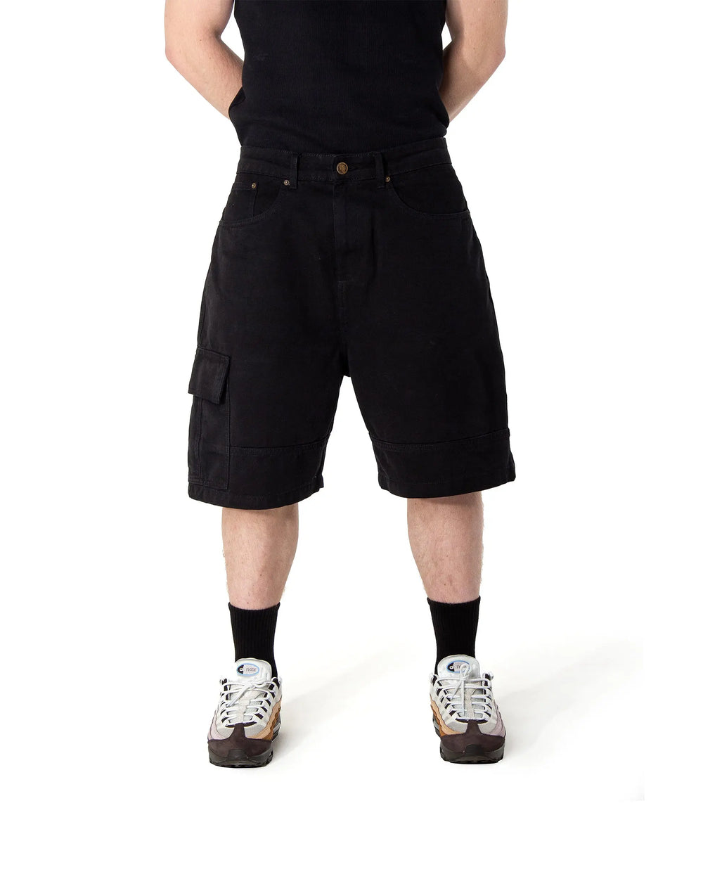 Person wearing black cargo shorts on a white background