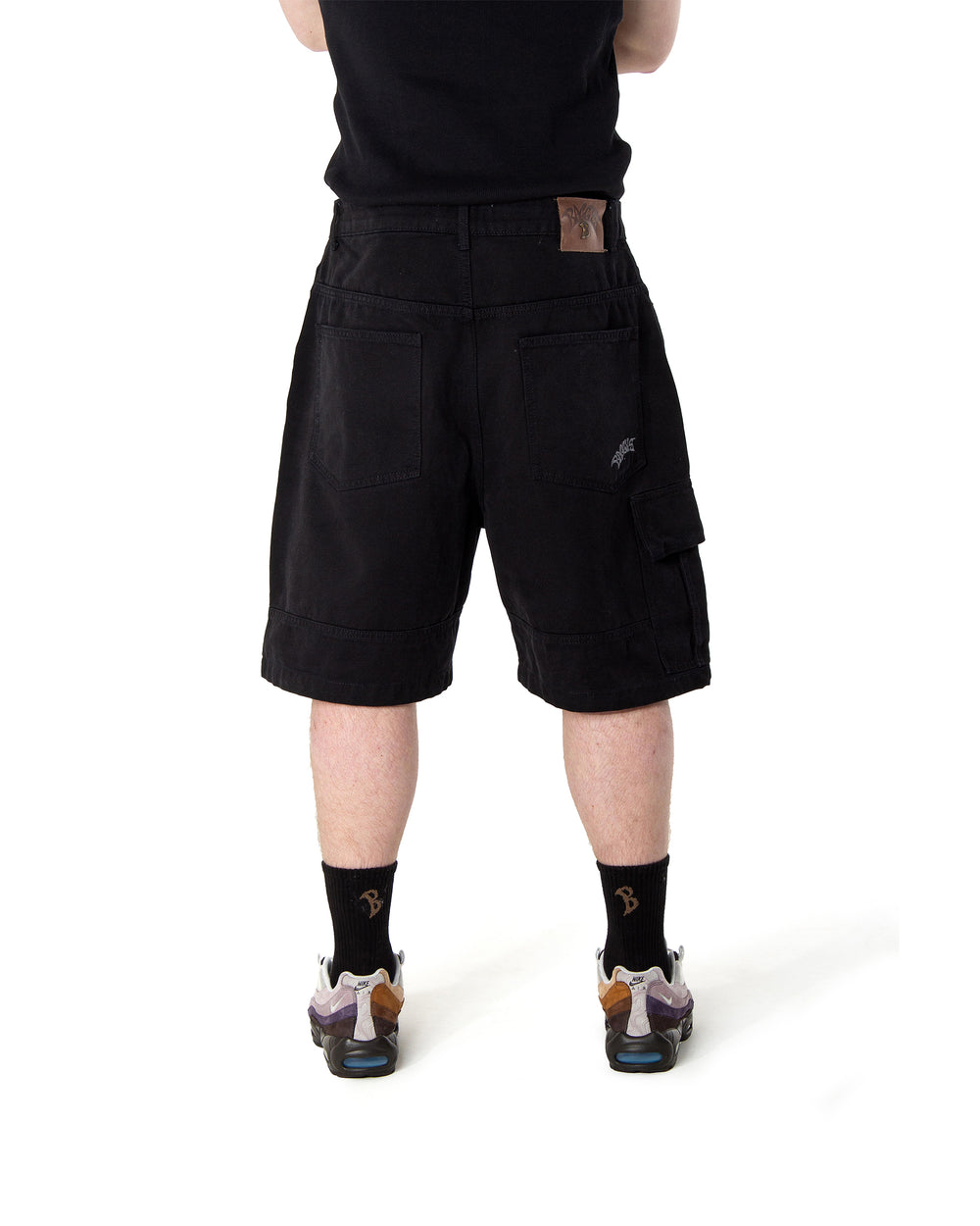 Person wearing black shorts on a white background