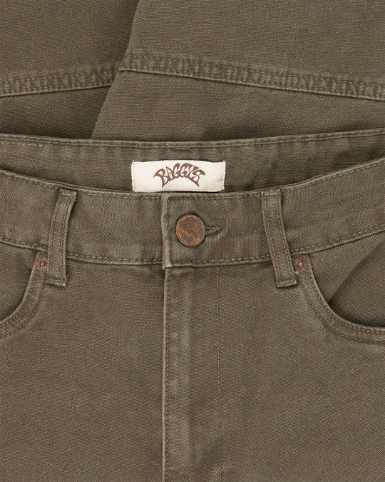 Close-up of a brown pants waistband with a brand label and button.