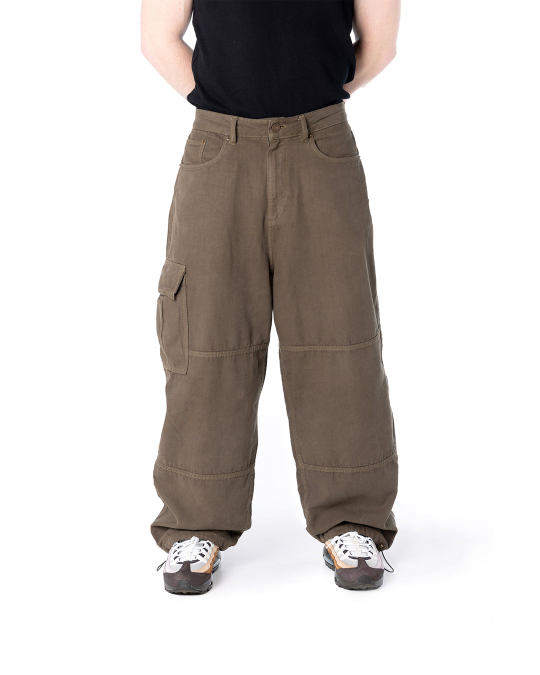 Person wearing brown cargo pants on a white background