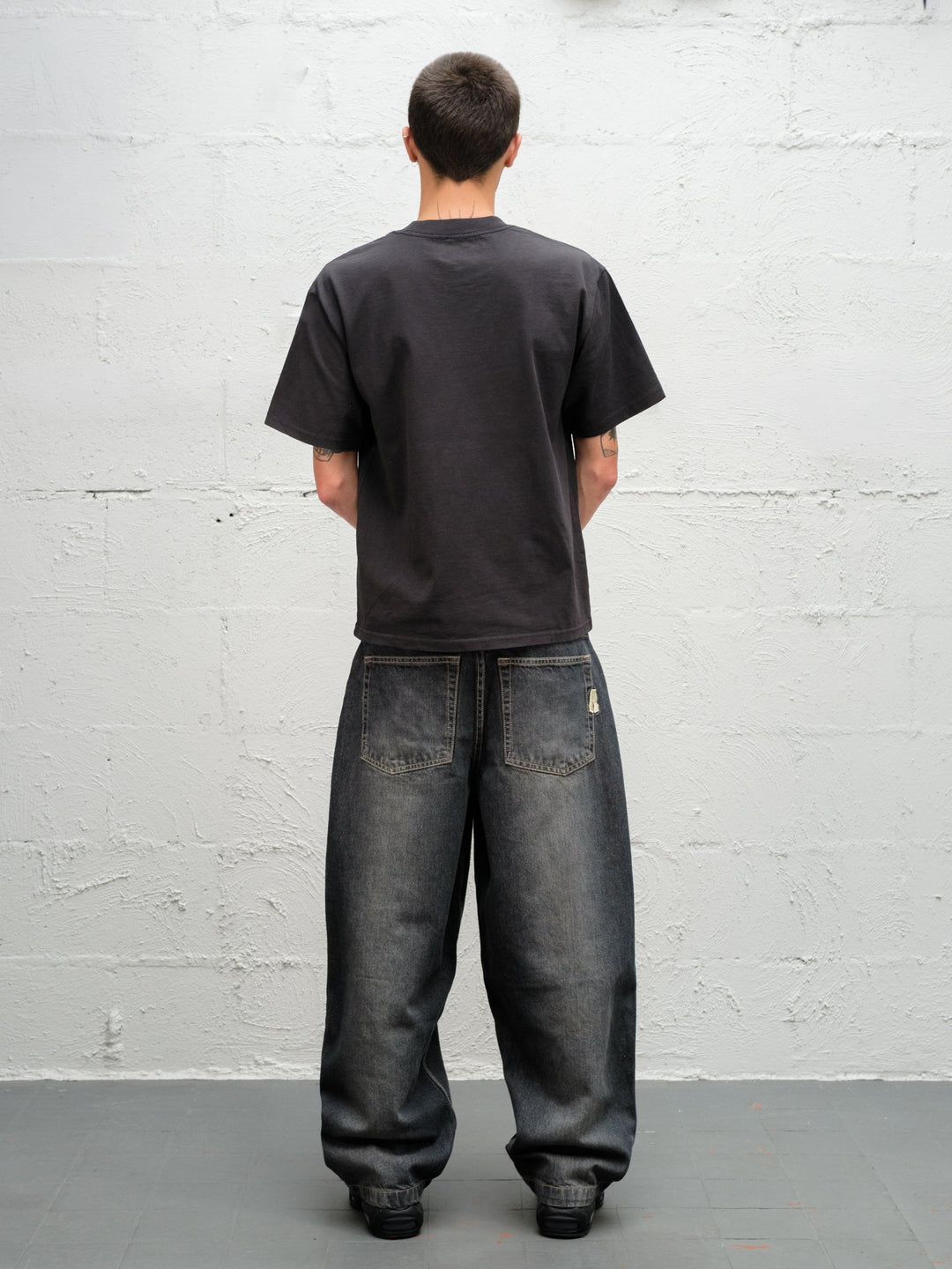 Model wearing grab tee with Denim Pant | Flint full rear view
