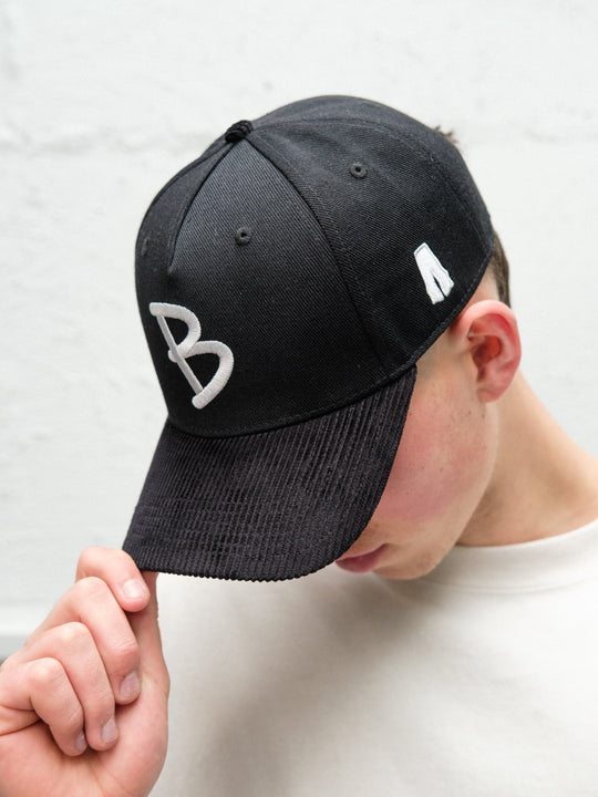 Person wearing Baggys 5-panel hat in black up close